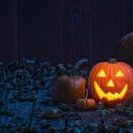 Smiling Jack O' Lantern on old wooden porch in the moon light