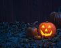 Smiling Jack O' Lantern on old wooden porch in the moon light