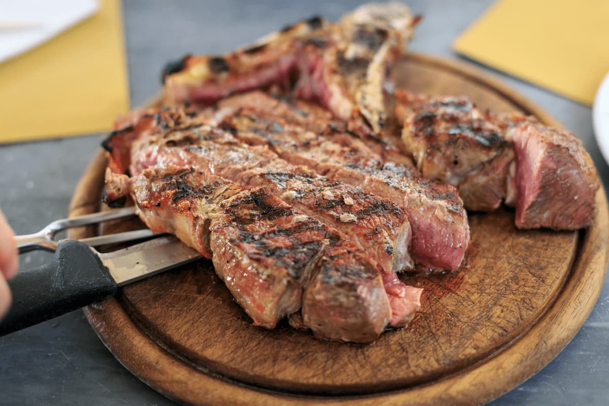 Grilled T-bone steak, known as Bistecca alla Fiorentina, is a Tuscan specialty