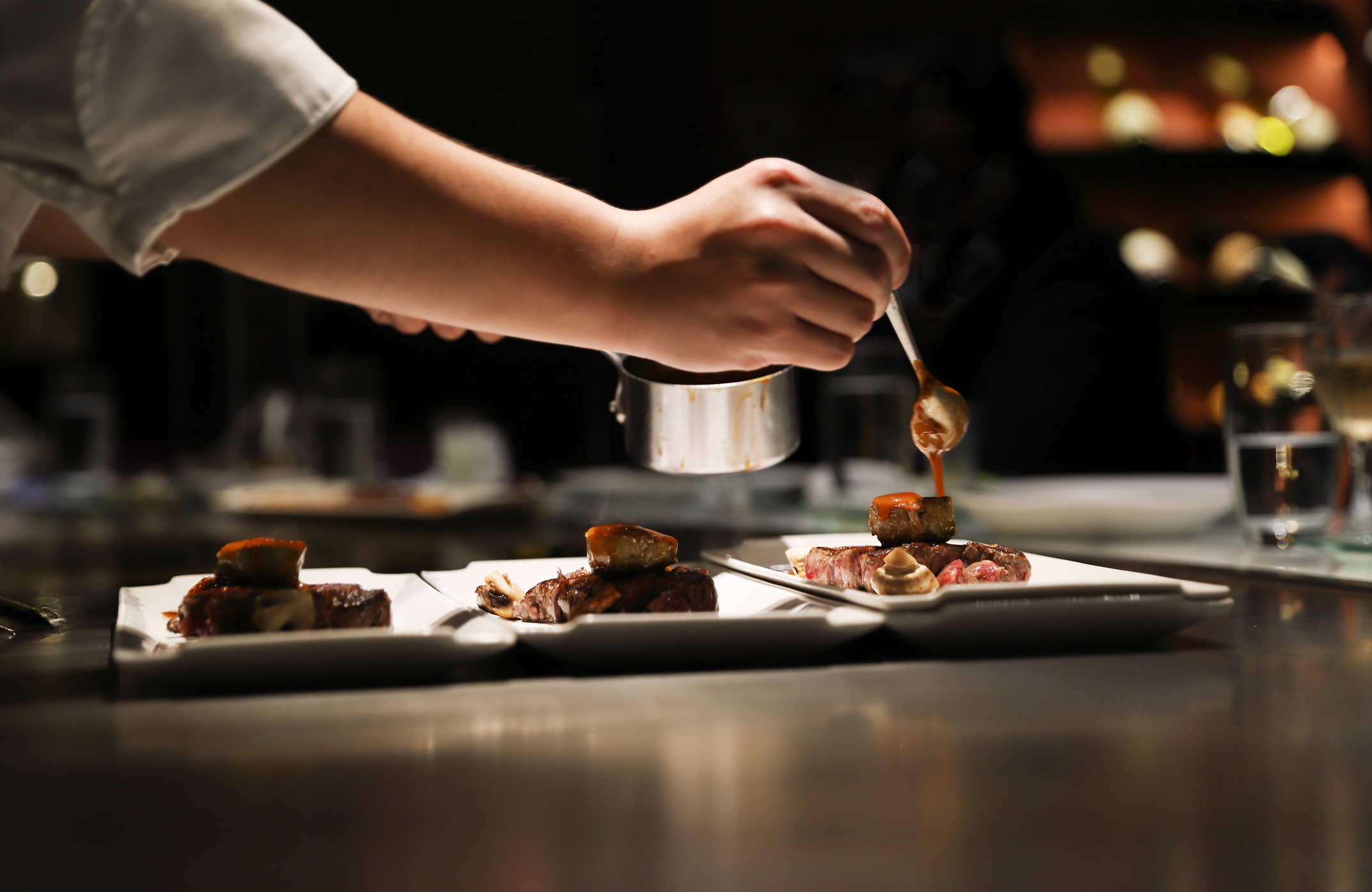 Teppanyaki chef cooking in front of guests.