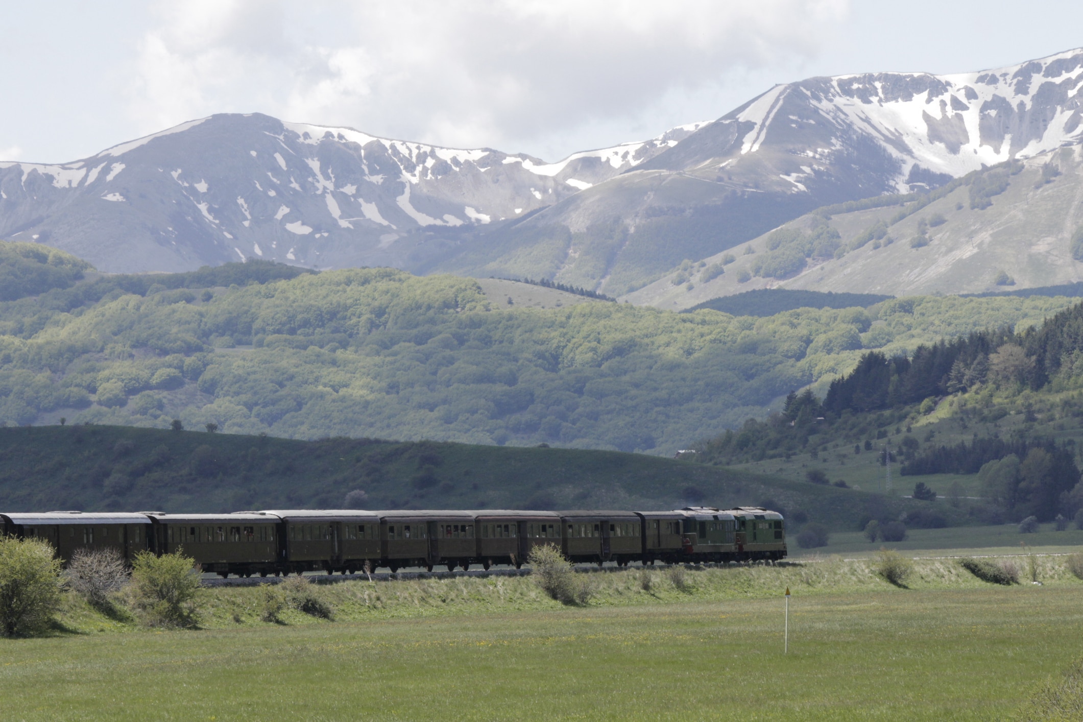 Pescocostanzo, province of L'Aquila, Italy. Railroad crossing the highlands of Pescocostanzo is a line of mountains that allows you to discover landscapes of incomparable beauty. It is waiting to be revitalized by tourist trains like the one in the picture.