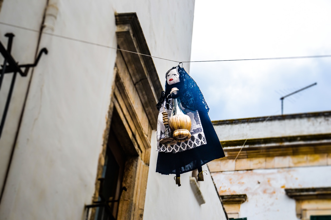 Typical Epiphany scene in Italy with a Befana hanging on a cable