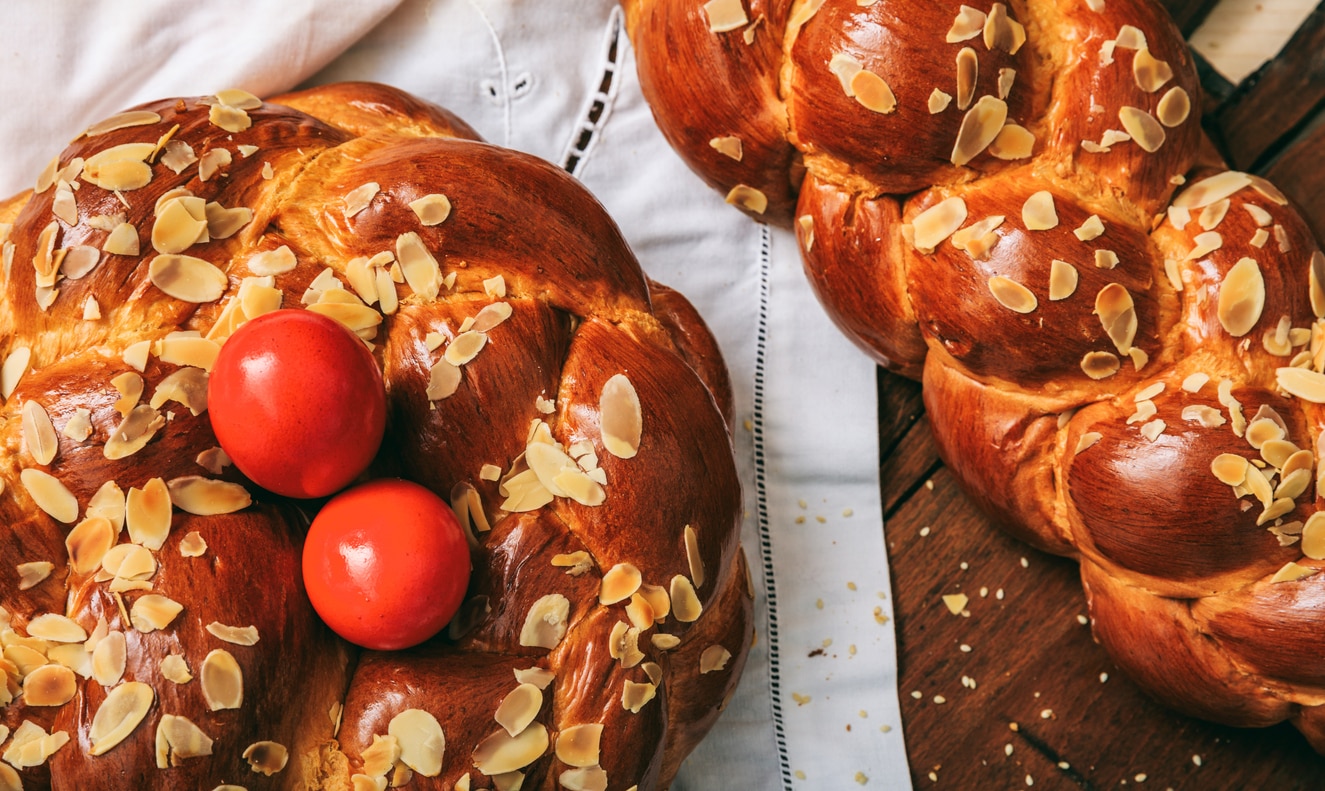 Easter traditional bread and red eggs on a table -  top view